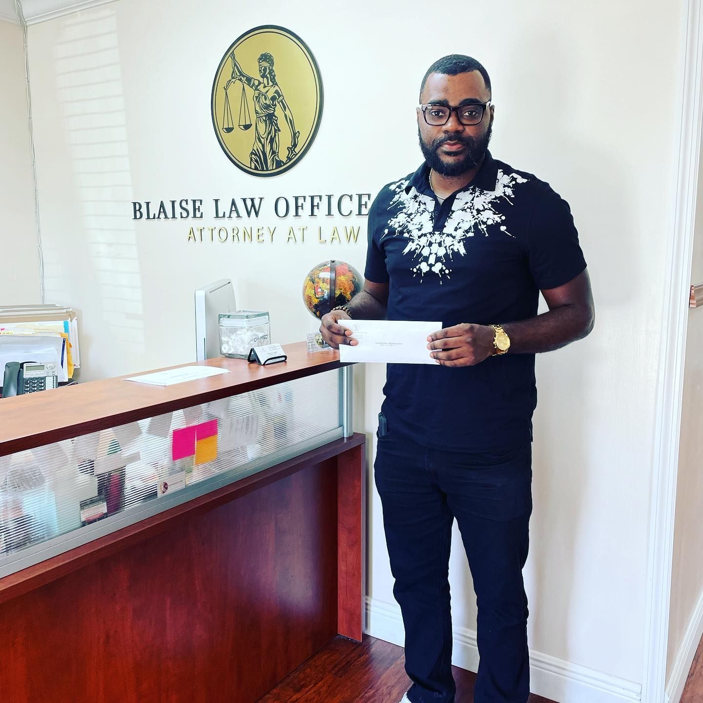 A Blaise Law Office client showing a check that represents their personal injury law suit results.