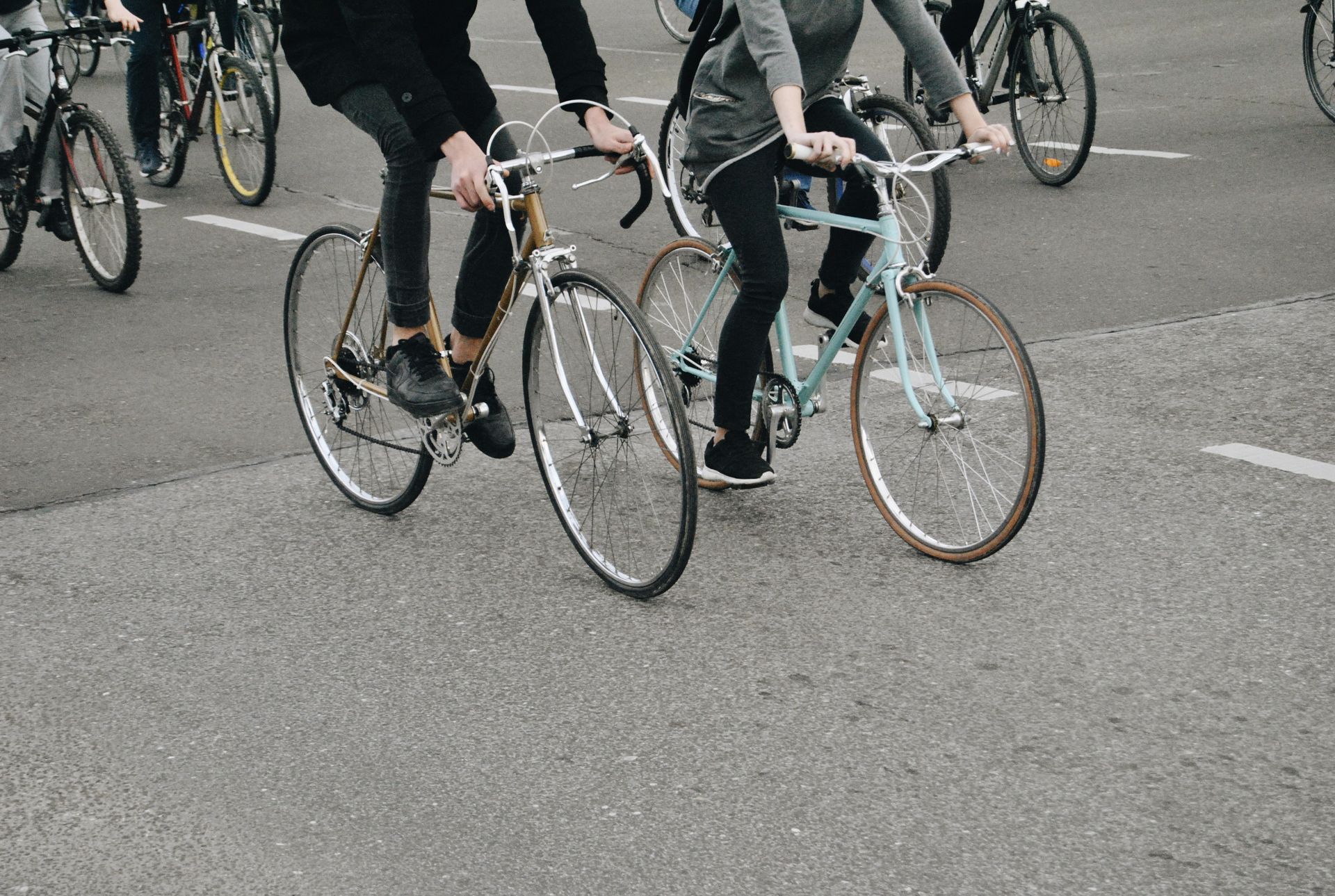 People riding bicycles on a paved road.