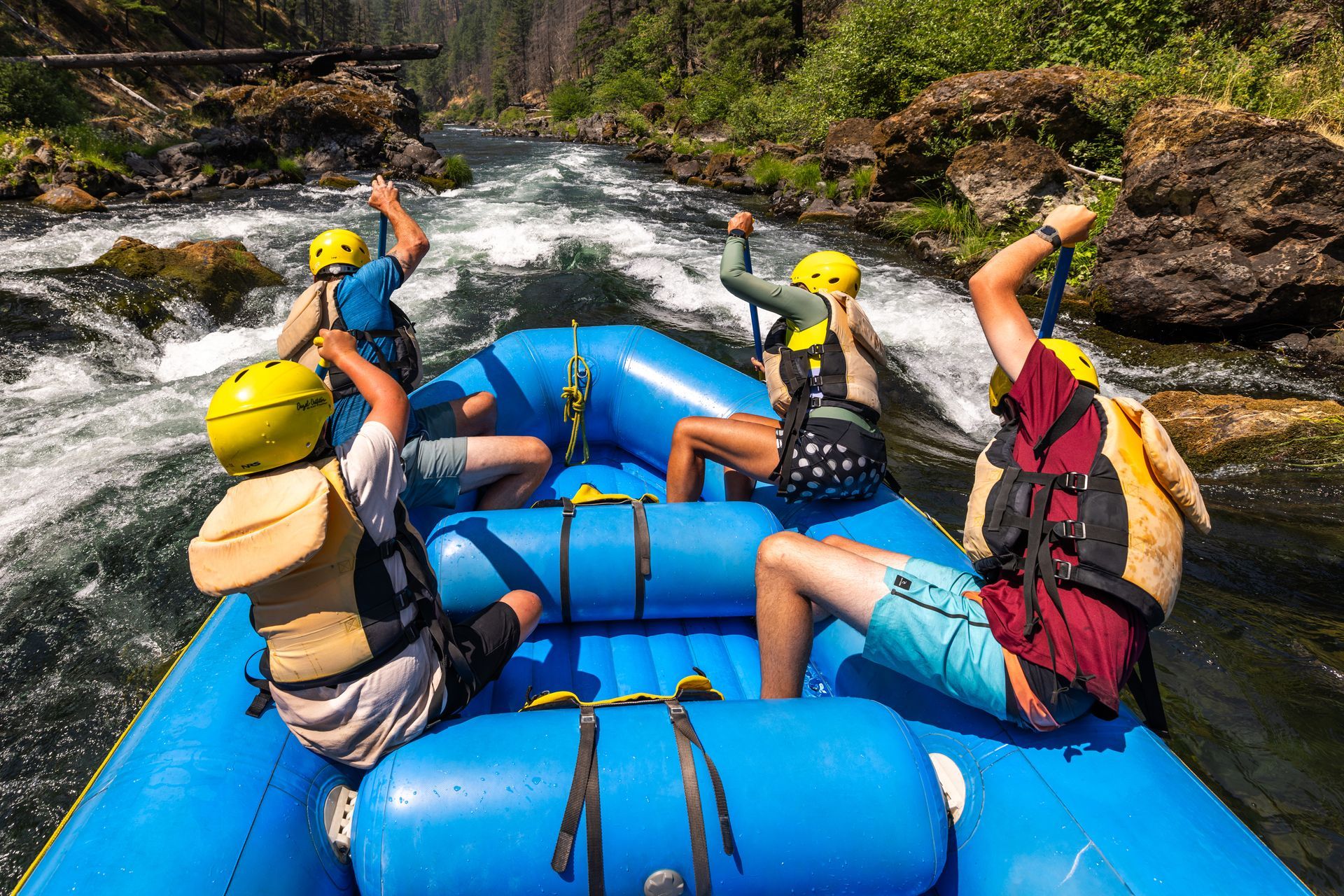 A group approaching rapids on a river raft.