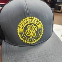 Gray cap with a yellow Gearheads Garage logo and gears on the front panel