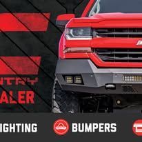 Red truck front with black-and-red promo graphic and text for lighting and bumpers