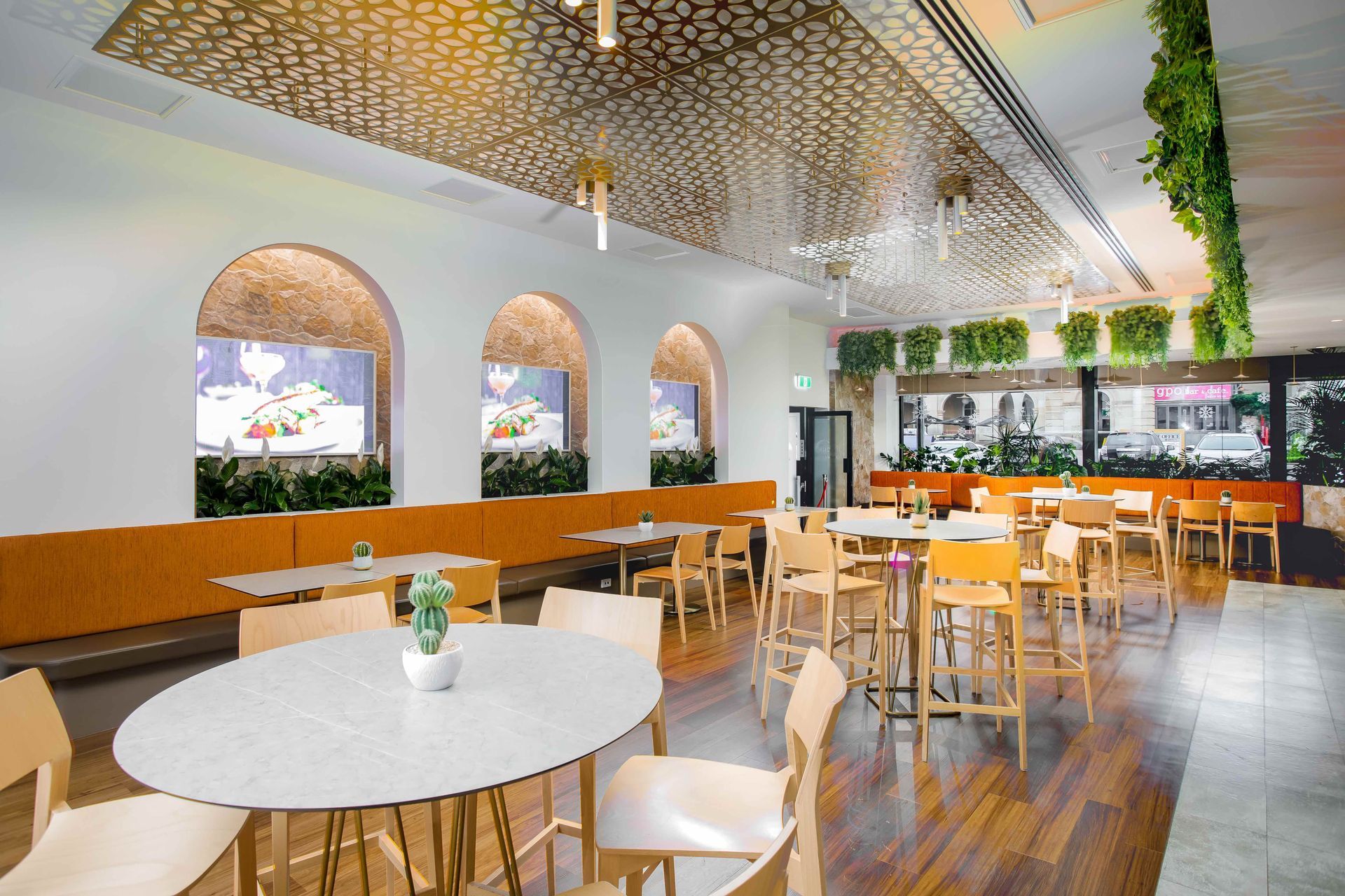 There are many tables and chairs in the restaurant.