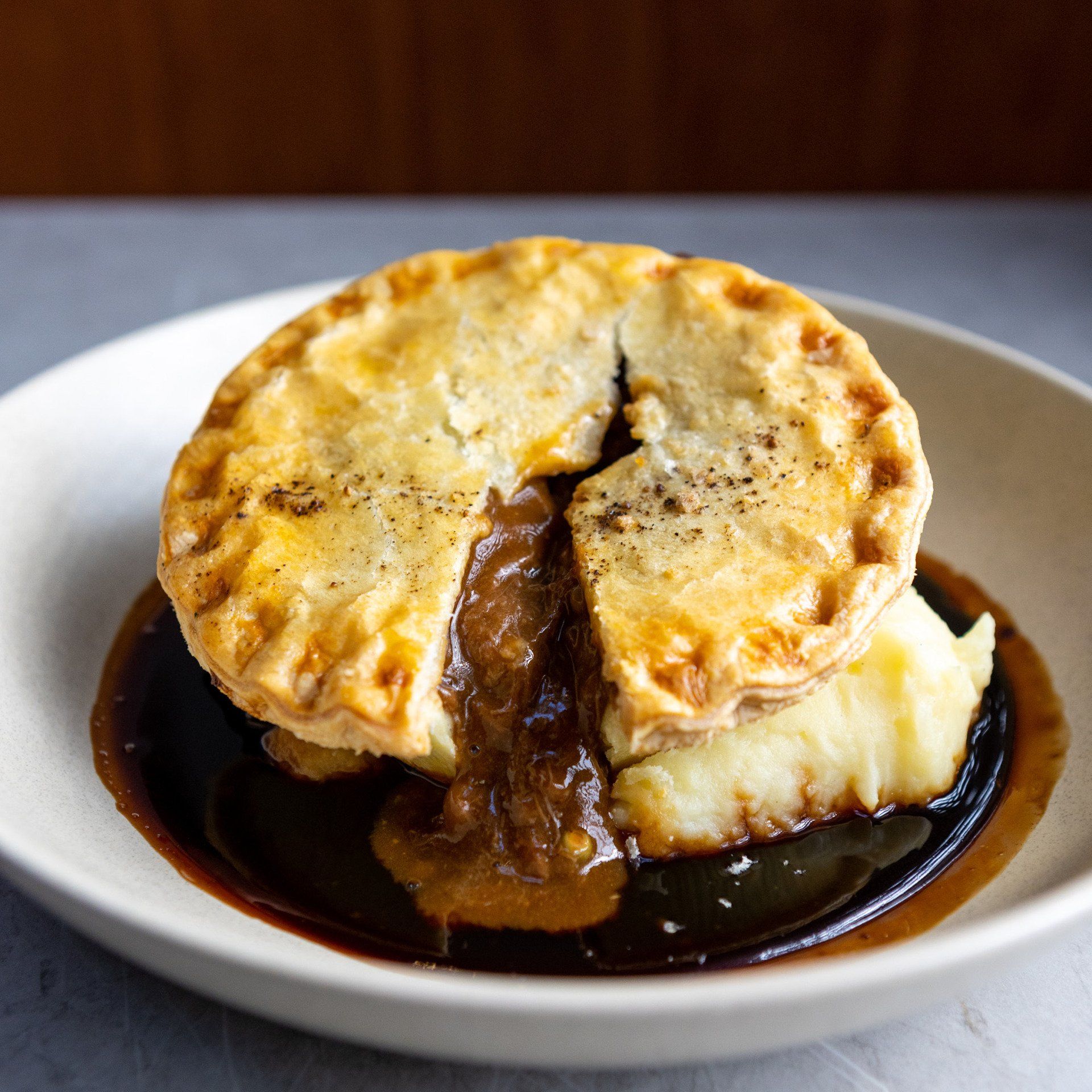 A pie with mashed potatoes and gravy on a plate
