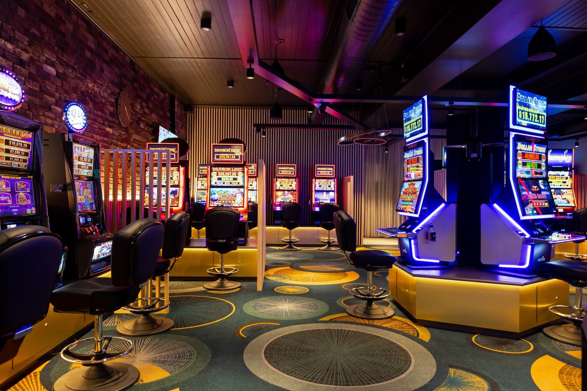 A casino with a lot of slot machines and chairs