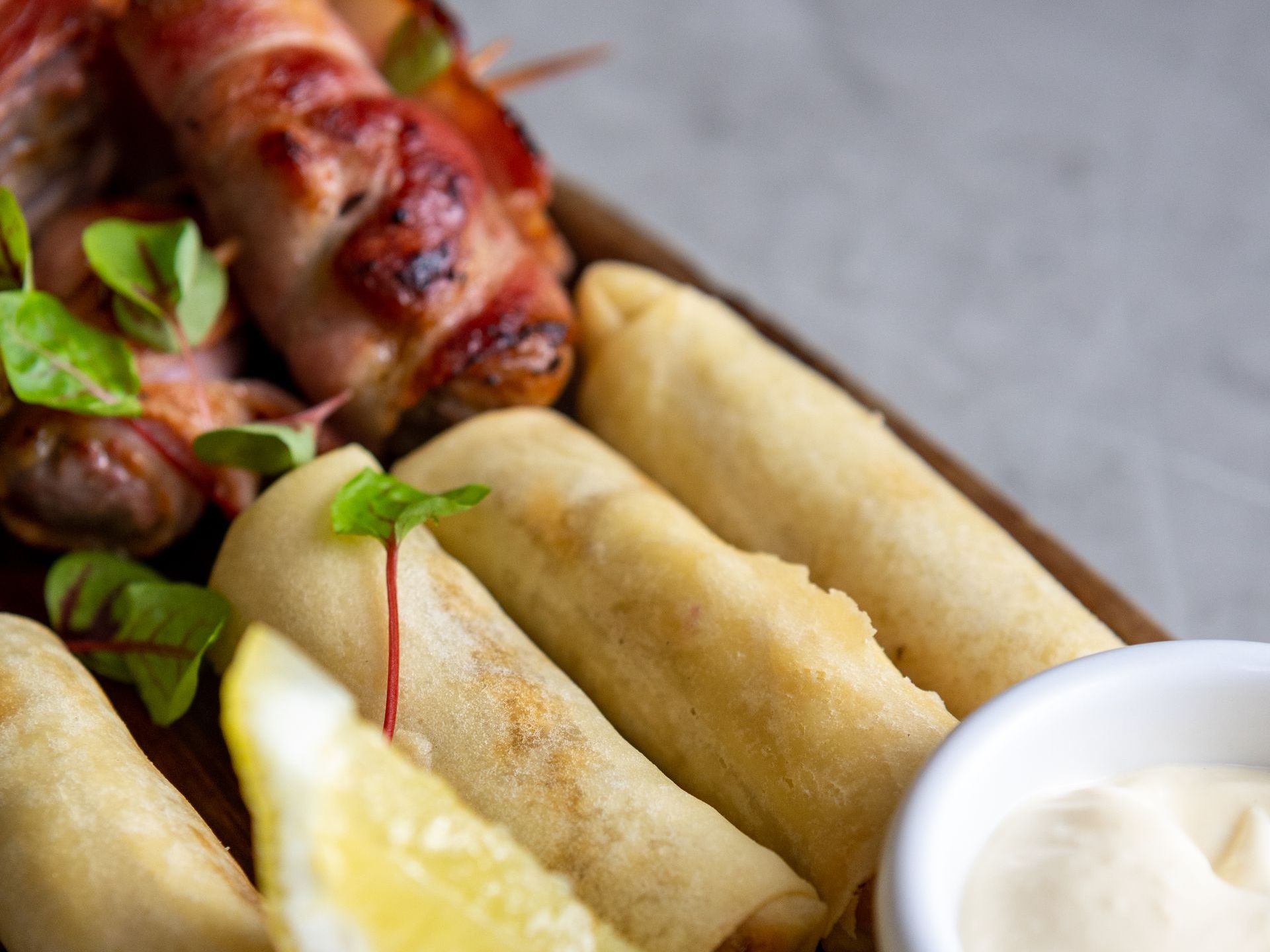 A close up of a plate of food with a bowl of mayonnaise.