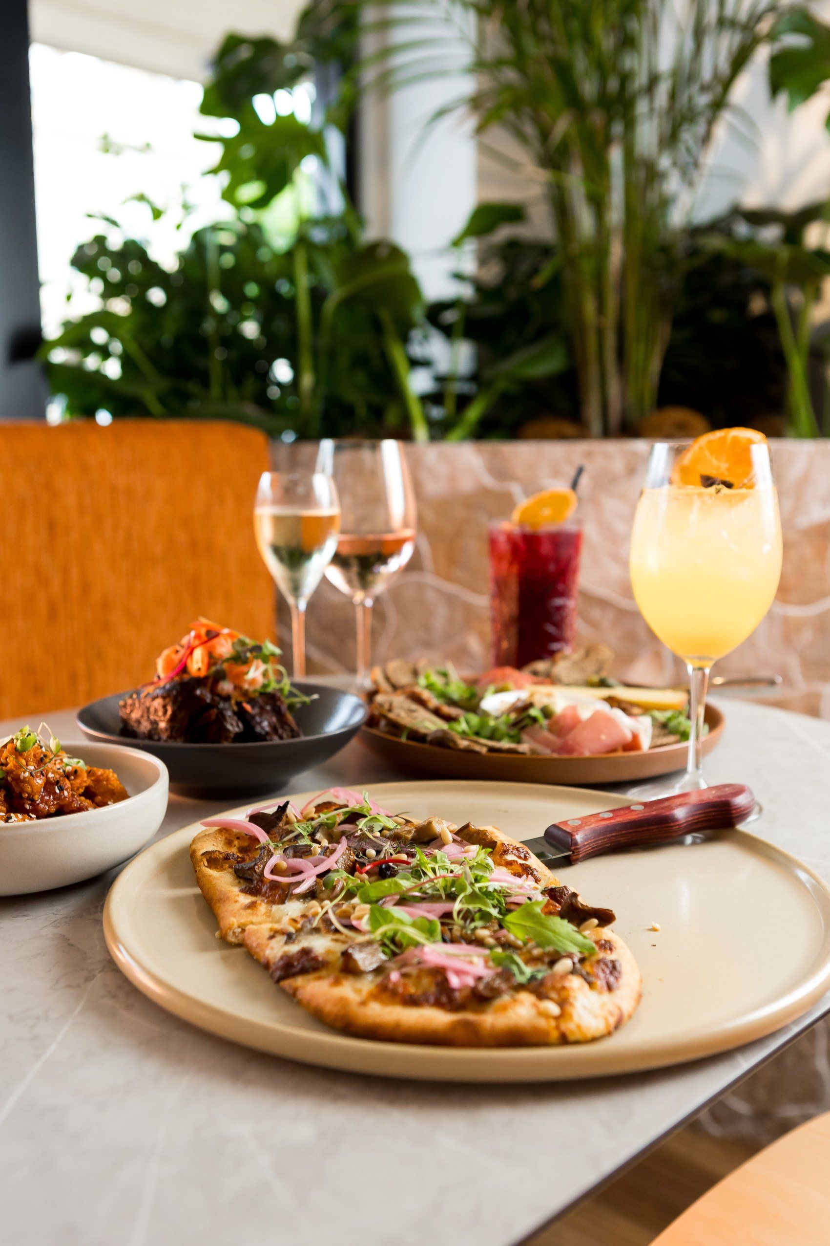 A table topped with plates of food and drinks.