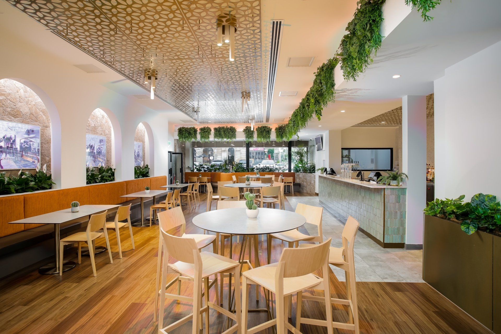 A function room with tables and chairs and a bar.