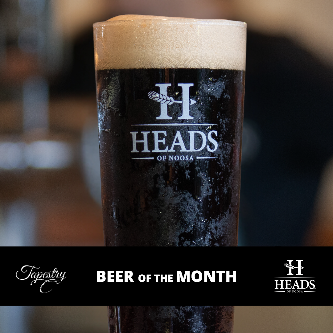 A glass of beer with the word heads on it