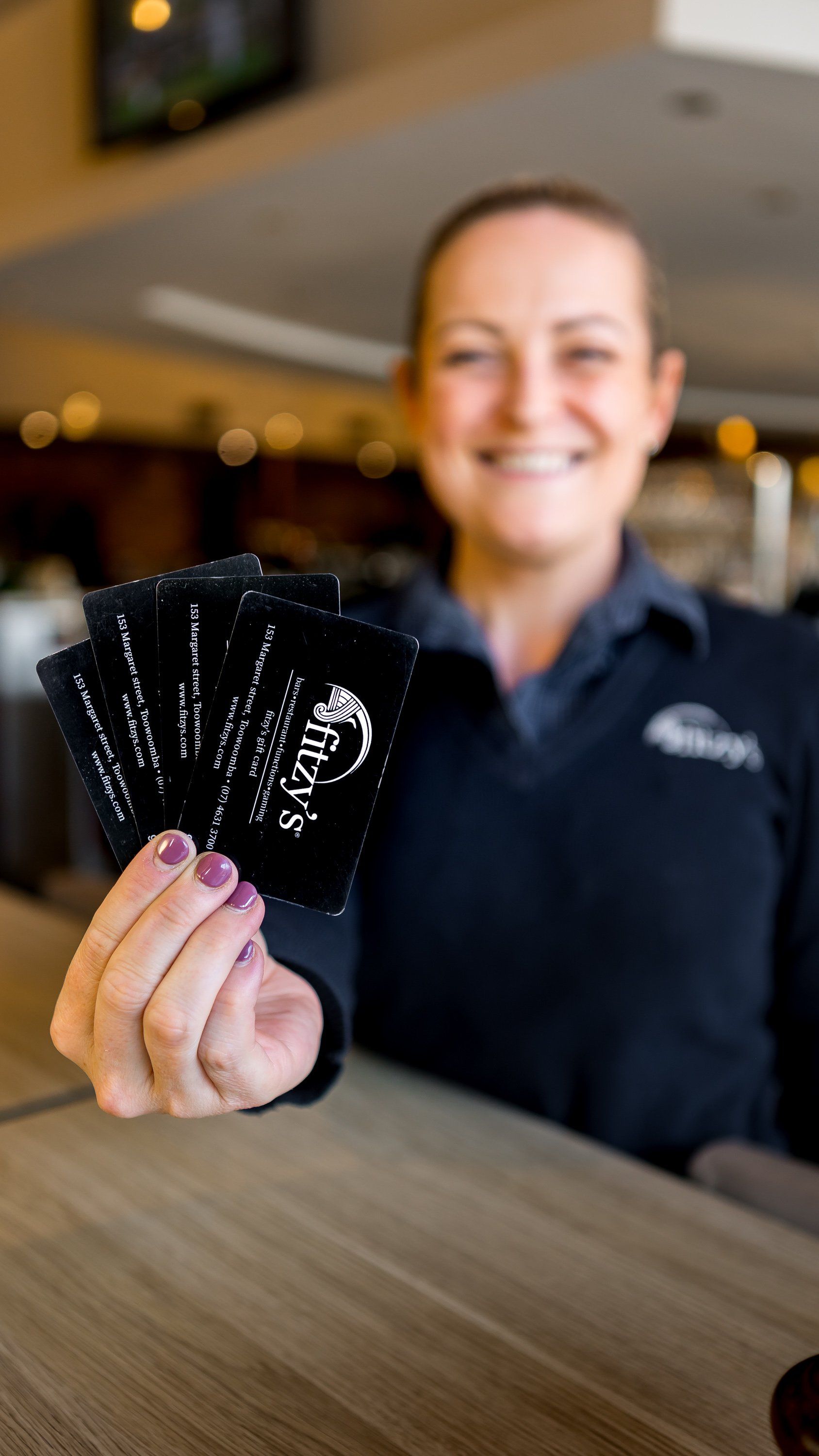 A woman is holding a bunch of cards in her hands.