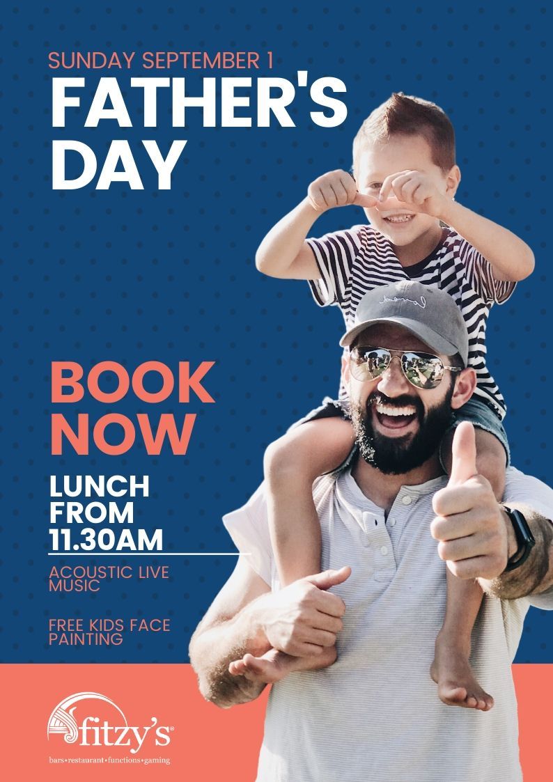 A man is carrying a child on his shoulders and giving a thumbs up.
