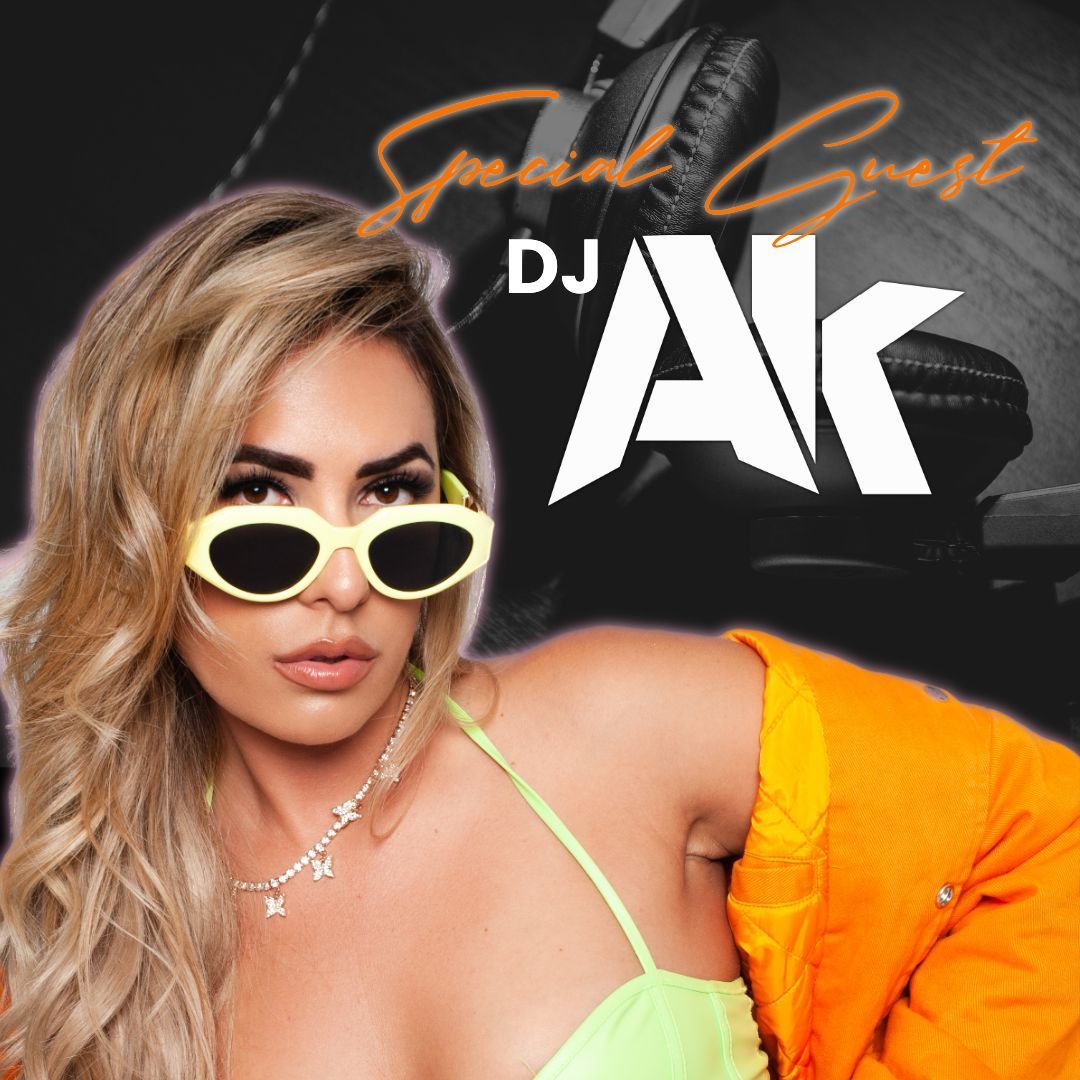 A woman wearing sunglasses and an orange jacket with the dj ak logo behind her