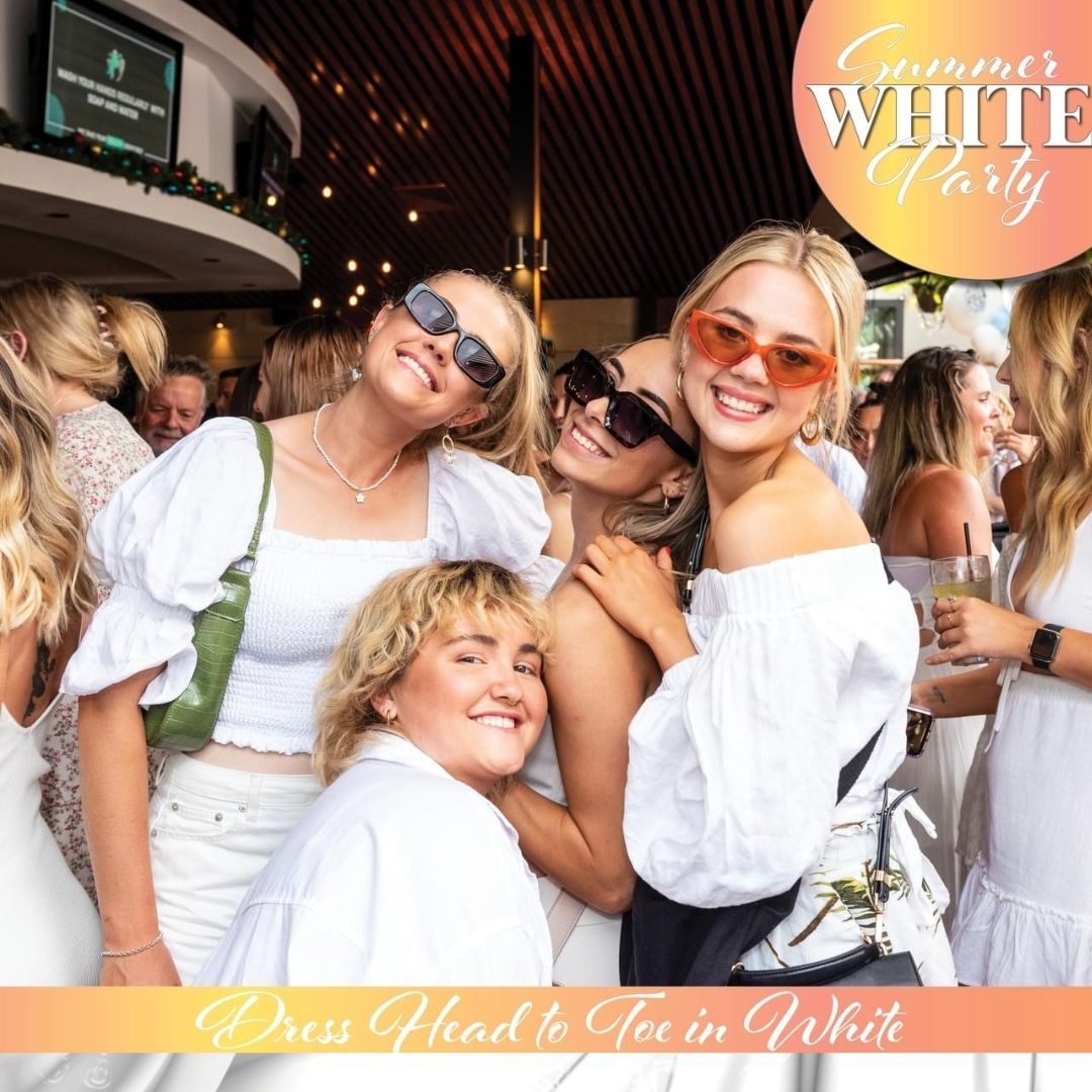 A group of women are posing for a picture at a summer white party