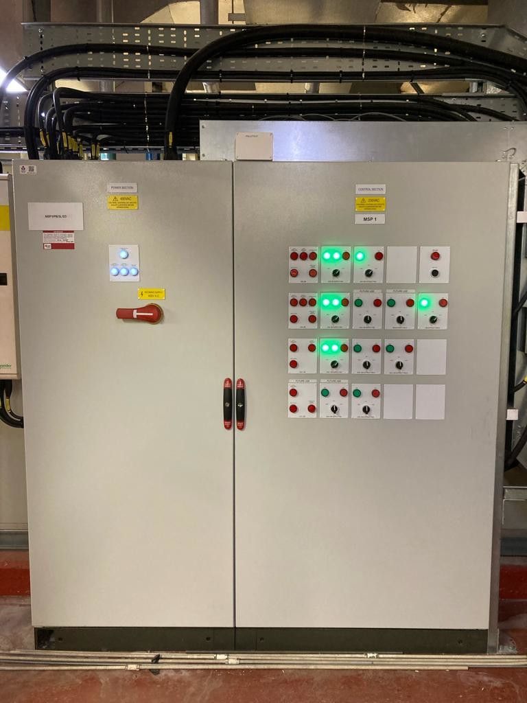 A large white elec cabinet box with a lot of buttons on it