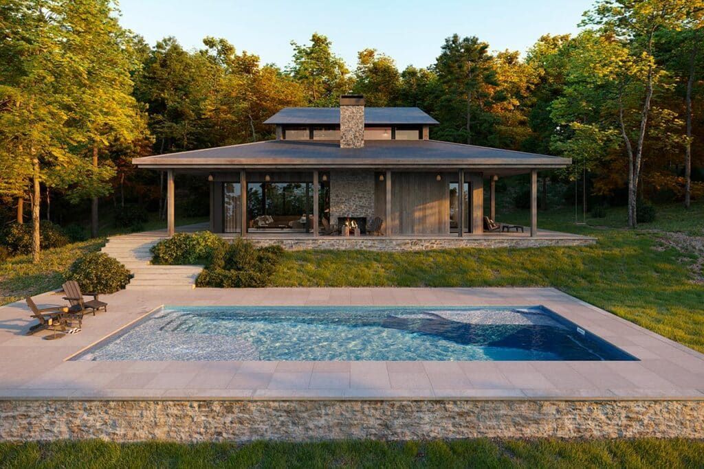 Modern house with covered porch behind a swimming pool at sunset, surrounded by trees