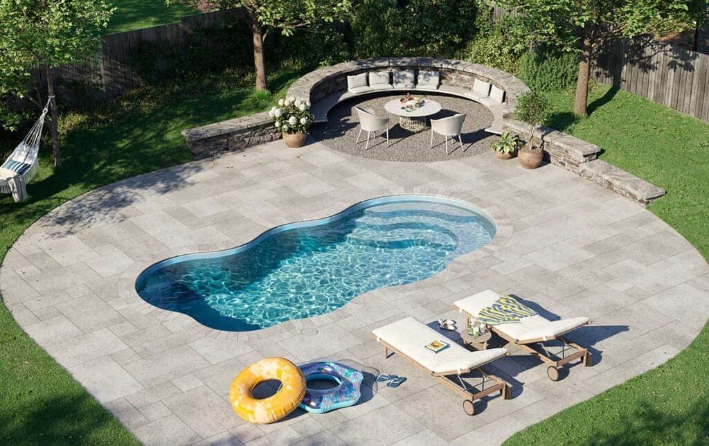 Backyard pool with lounge chairs, yellow float, and stone seating area under trees