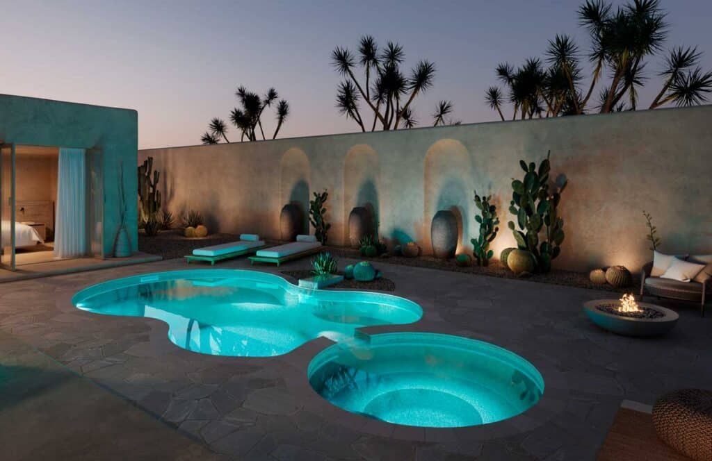 Illuminated turquoise pool with circular hot tubs in a modern desert patio at dusk