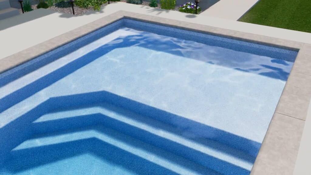 Blue-tiled swimming pool with stepped entry and light stone coping