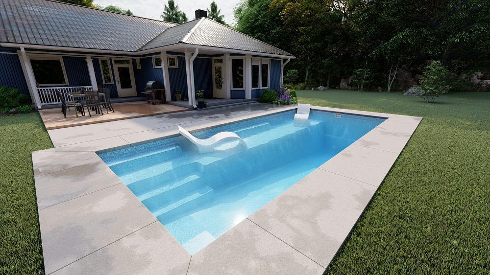 Backyard patio with a rectangular blue swimming pool beside a house and green lawn