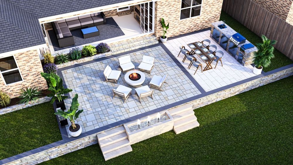 Outdoor stone patio with white chairs, fire pit, dining table, lounge seating, and steps down to the lawn