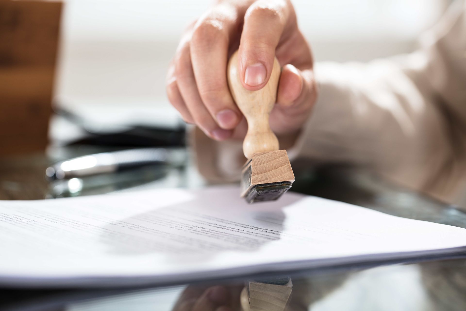 a person is stamping a piece of paper on a table