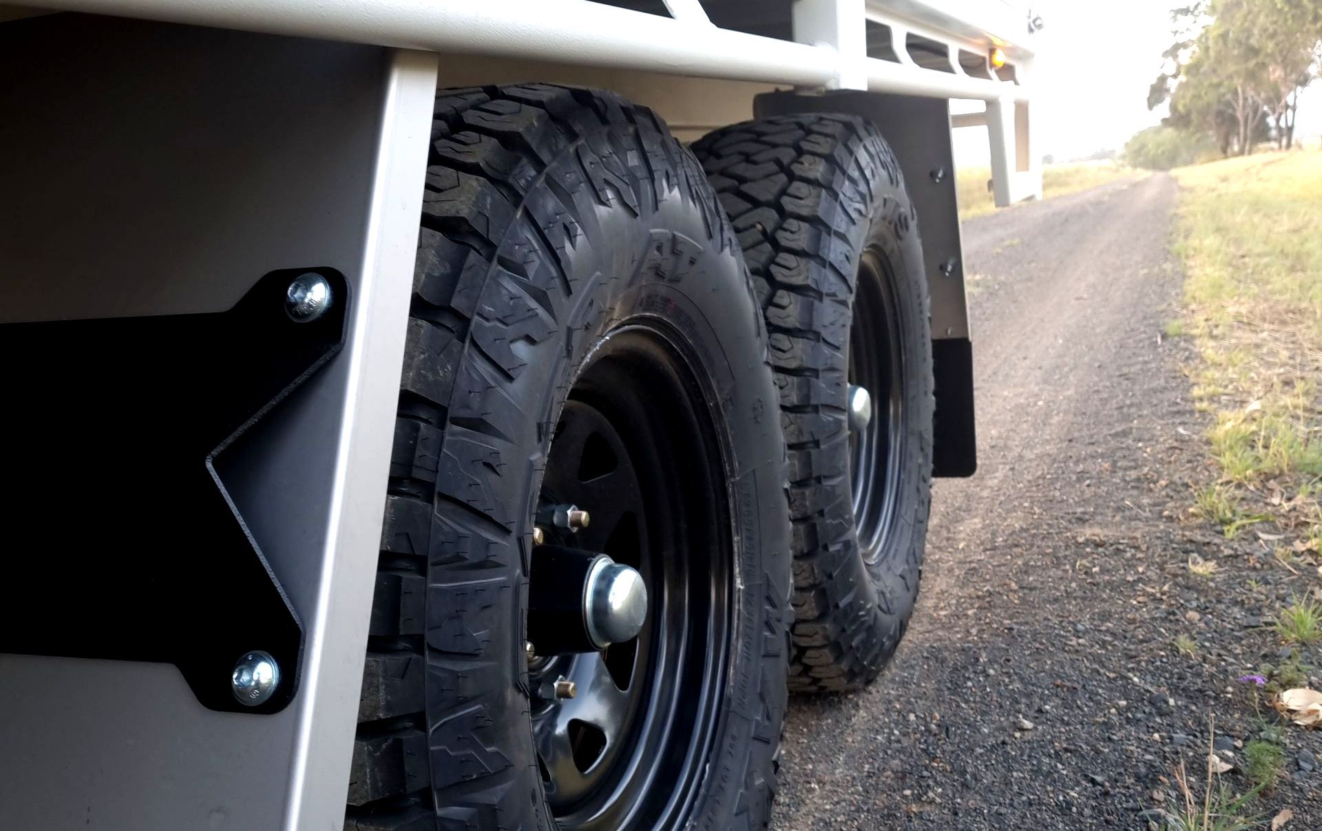 tandem axle trailer tyres and mudguards ox trailer flat top trailer on dirt road.