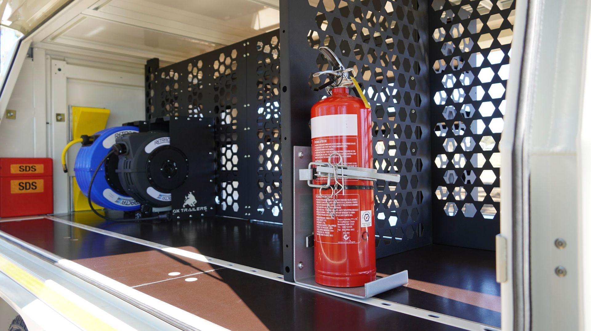 Secure fire extinguisher storage in custom service trailer for wasco energy by ox trailers.