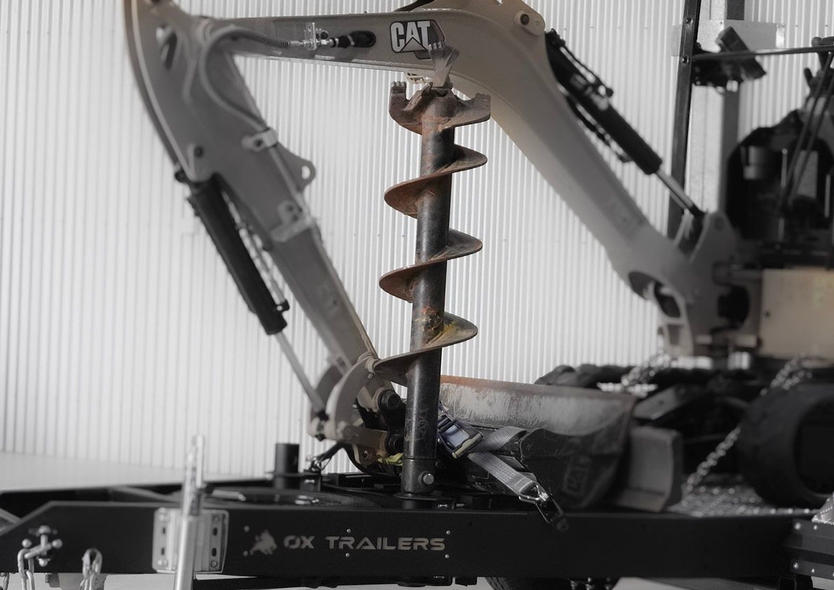 the skid steer spreader bar holder of an ox plant trailer.