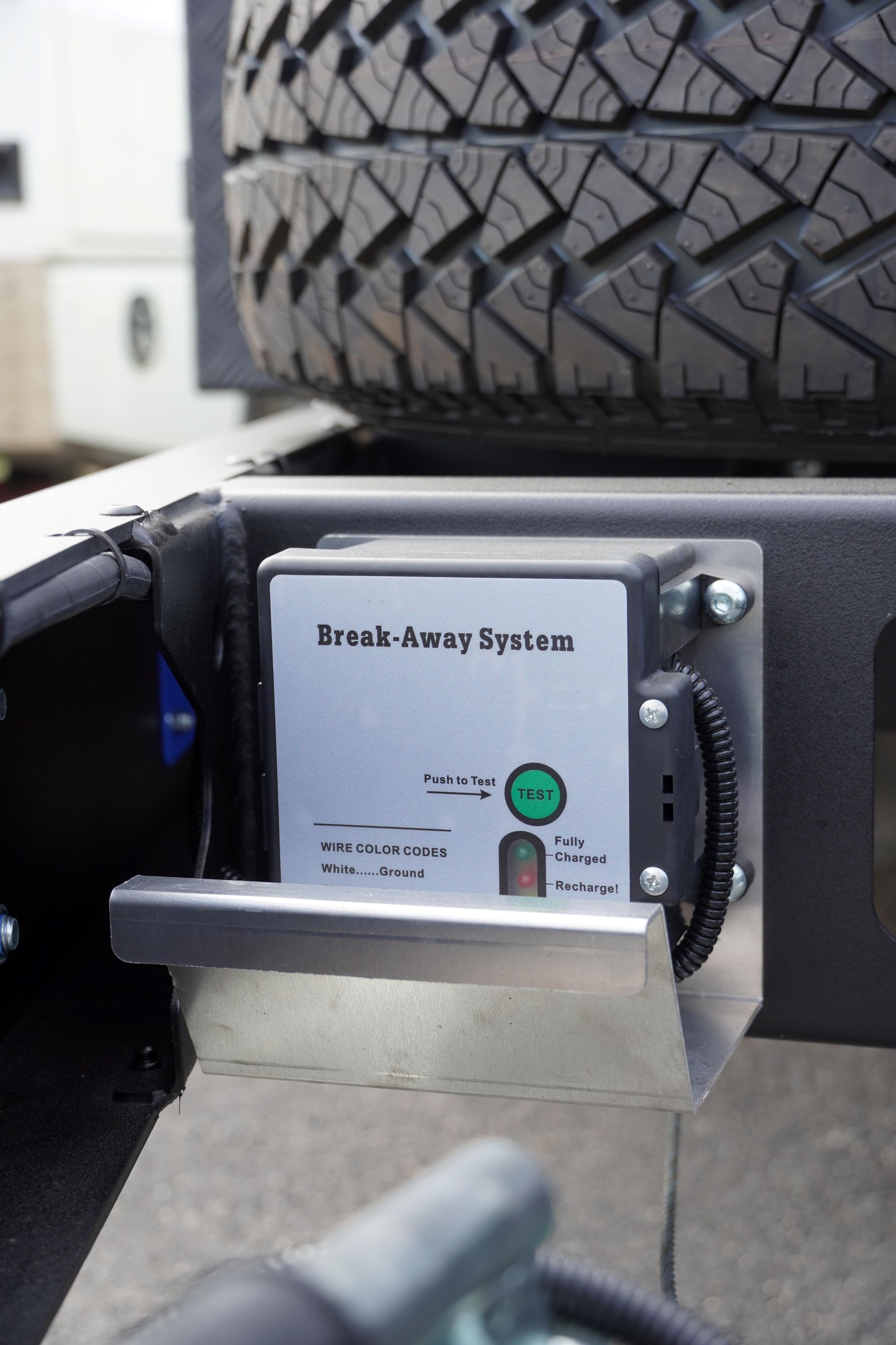 safe and secure ox trailers breakaway system with protected mount within the chassis.