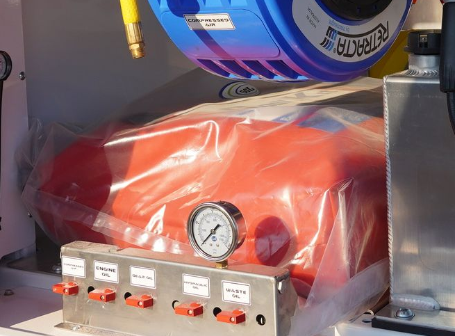 Plastic wrapped spill kit installed inside ox trailers service trailer canopy