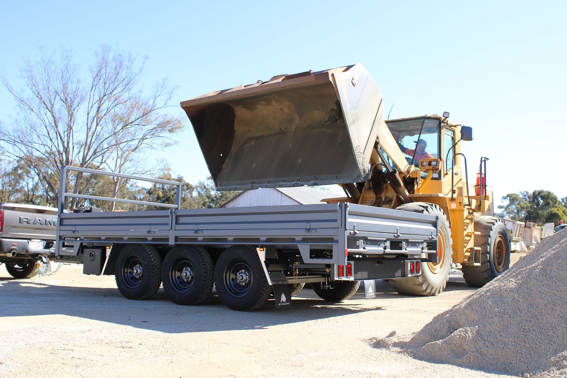 6m tri-axle trailer australian made by ox trailers, at quarry being filled with sand from large doze