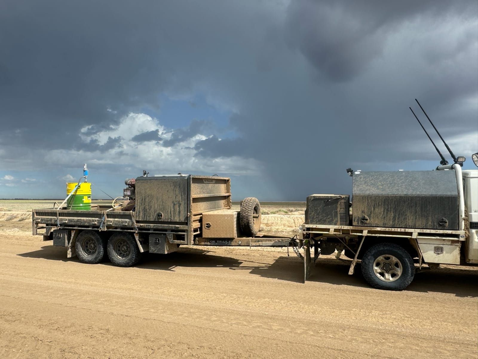 Tom Clarke's Flat Top Trailer towed by a Toyota Land Cruiser on a sandy road, with gear behind the canopy protected.