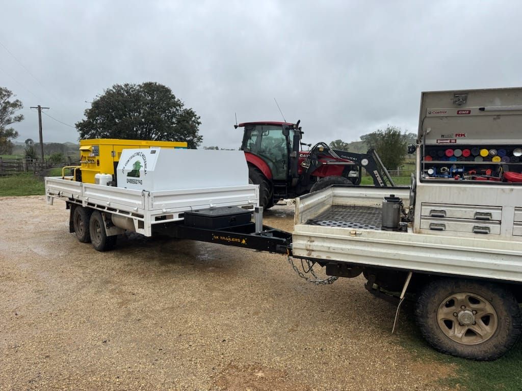 FlaT Top trailer with toolboxes at rural farm for servicing