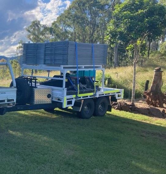 The monster hire flat top trailer fitted with extra accessories, and loaded with machinery a framing.