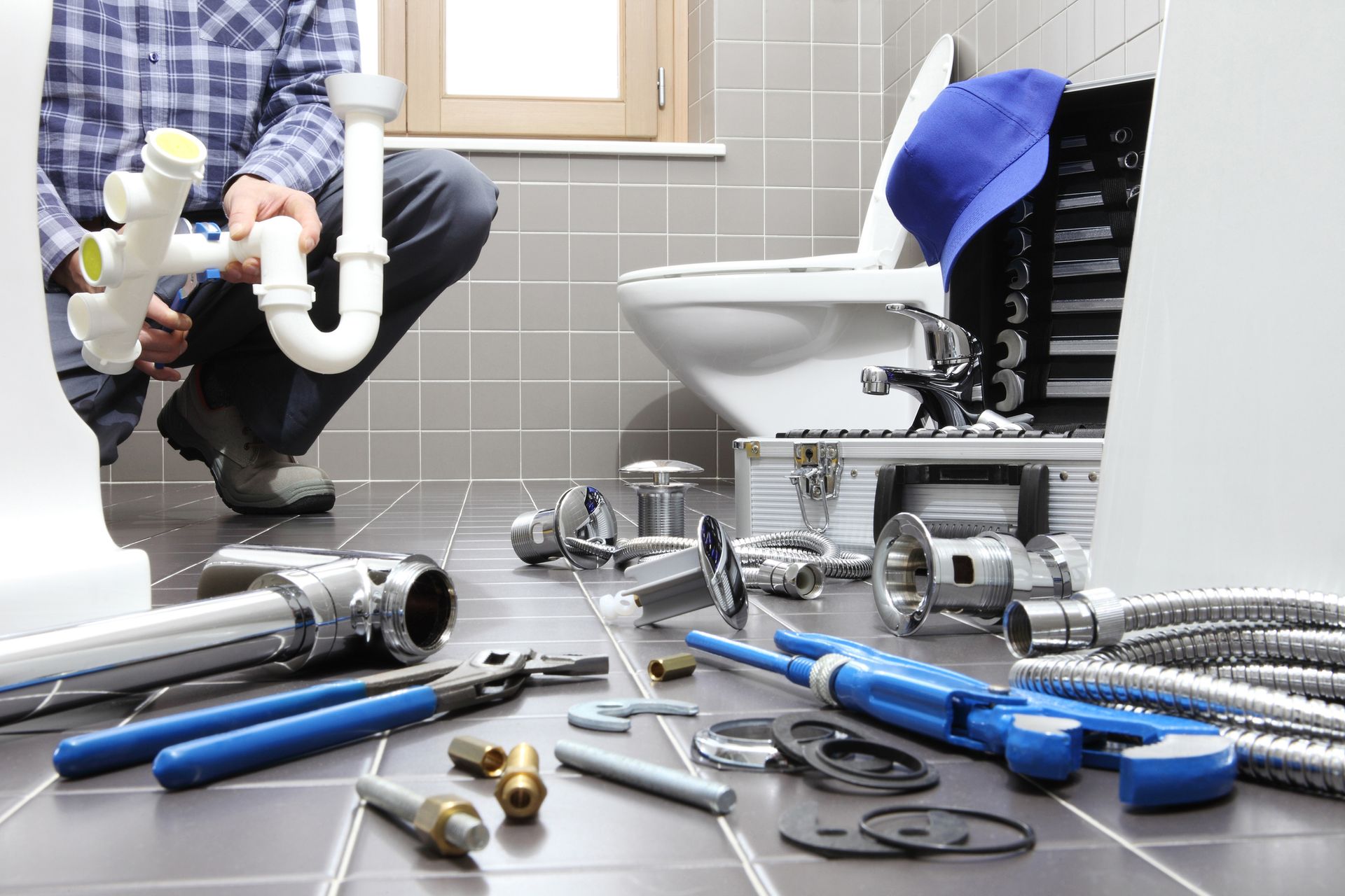 Professional plumbing installation contractor fitting new bathroom fixtures.