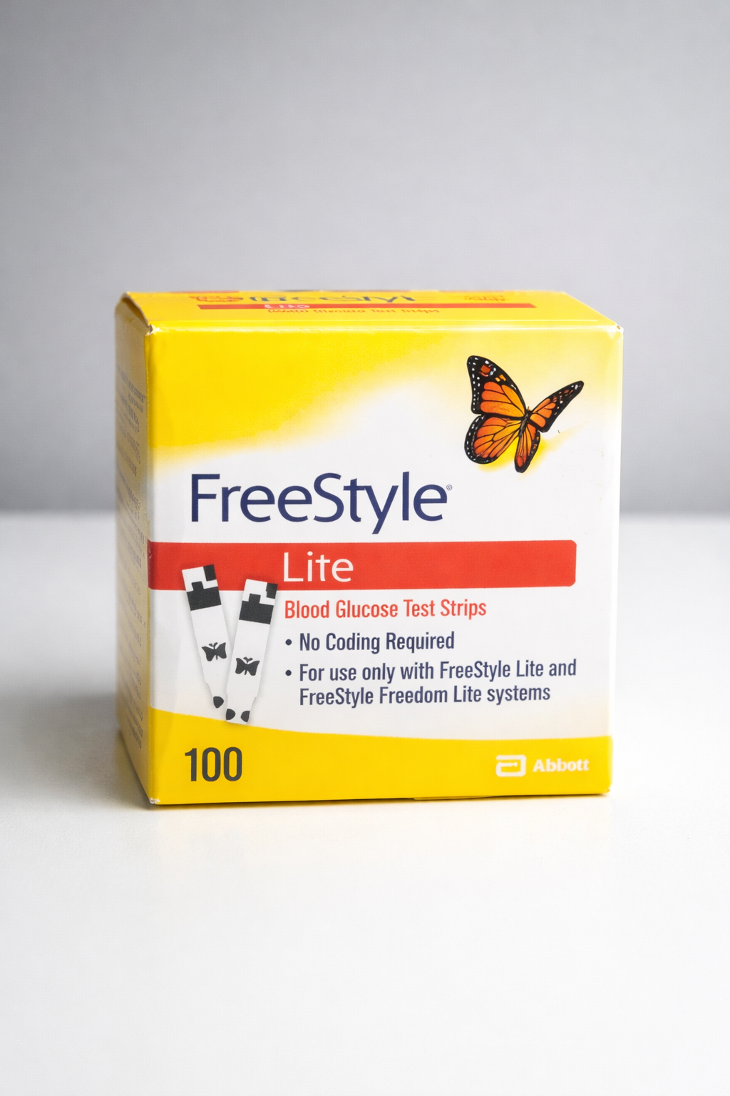 Box of FreeStyle Lite blood glucose test strips. Yellow and white box with orange accents and butterfly graphic.