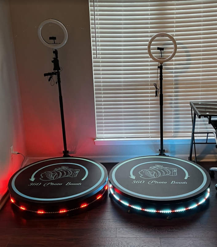 Two ring lights on stands beside illuminated circular platforms in a room with blinds.