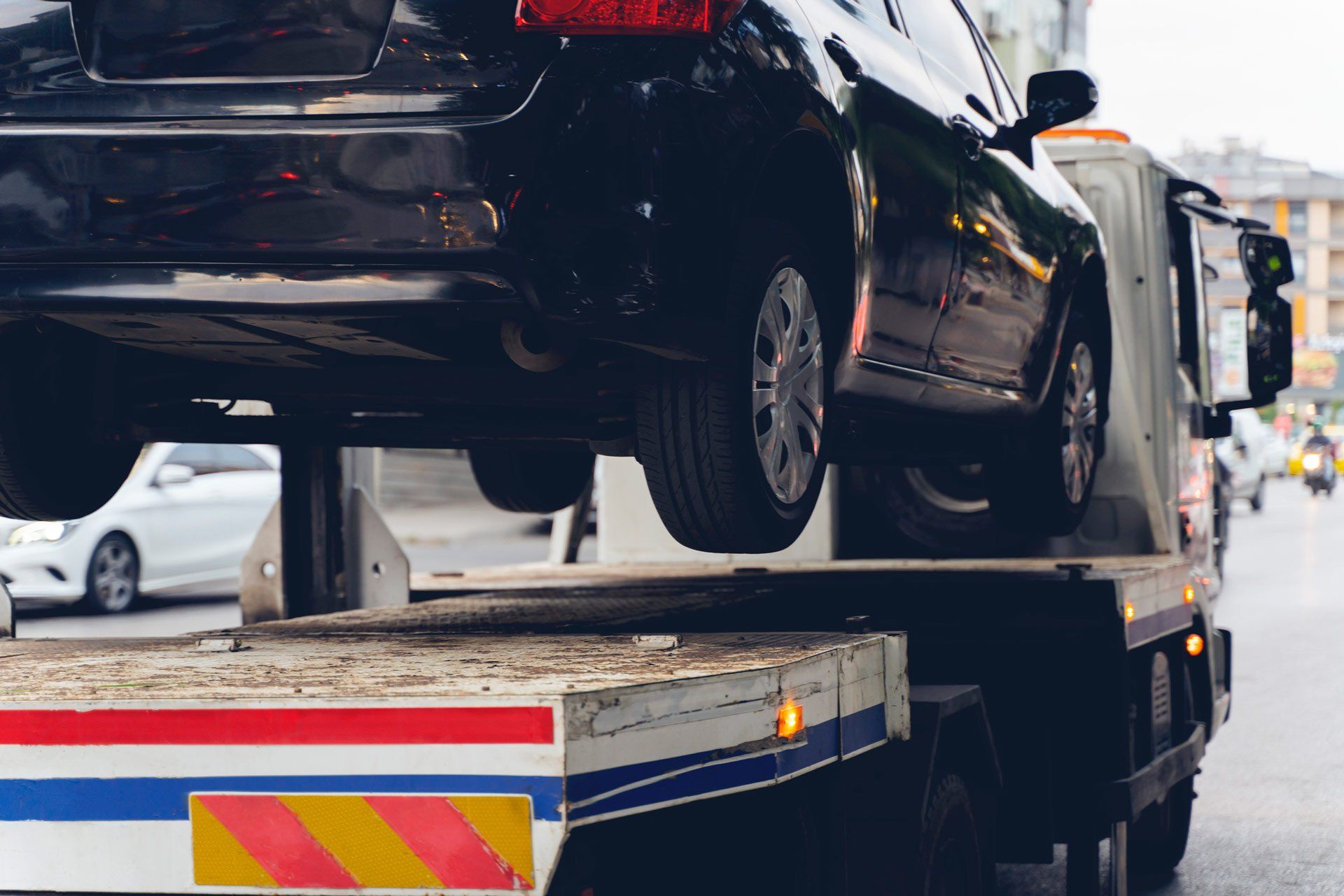 Black Broken Car on a Towing Truck — Brooklyn, Vic — Autocare Towing Pty Ltd