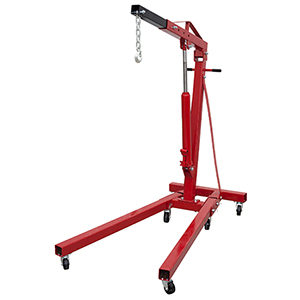 A red engine crane with wheels on a white background