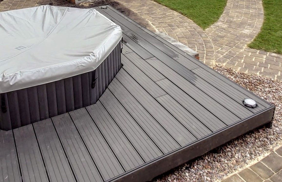 Zest Decking Mexborough - brown composite decking fitted around a hot tub