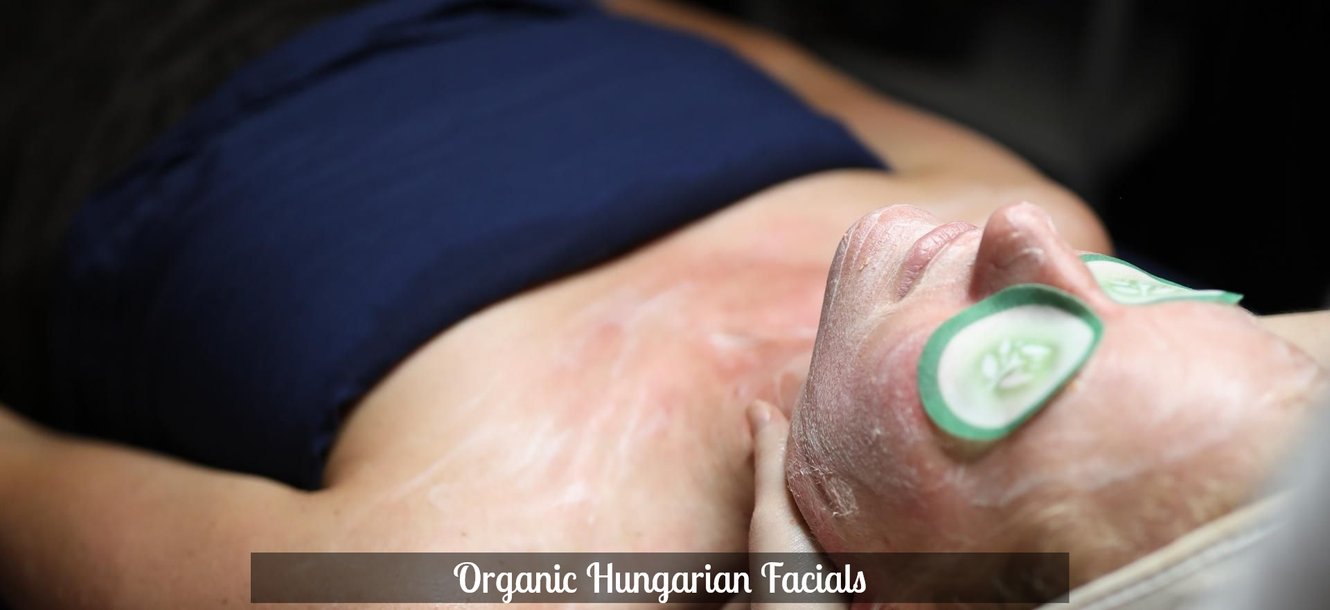 Person lying on a treatment bed with a green eye mask during a facial treatment