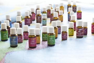 Small bottles of colorful essential oils arranged on a light surface