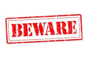 Red stamped “BEWARE” warning sign on a white background