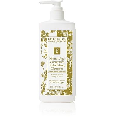 White Eminence skincare bottle with pump dispenser and gold floral label on a plain background