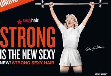 Woman lifting a barbell beside text reading “Strong is the New Sexy” for Sexy Hair branding