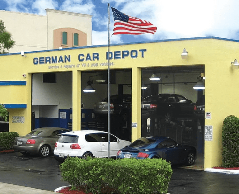 Image of auto repair shop store front with open garage doors