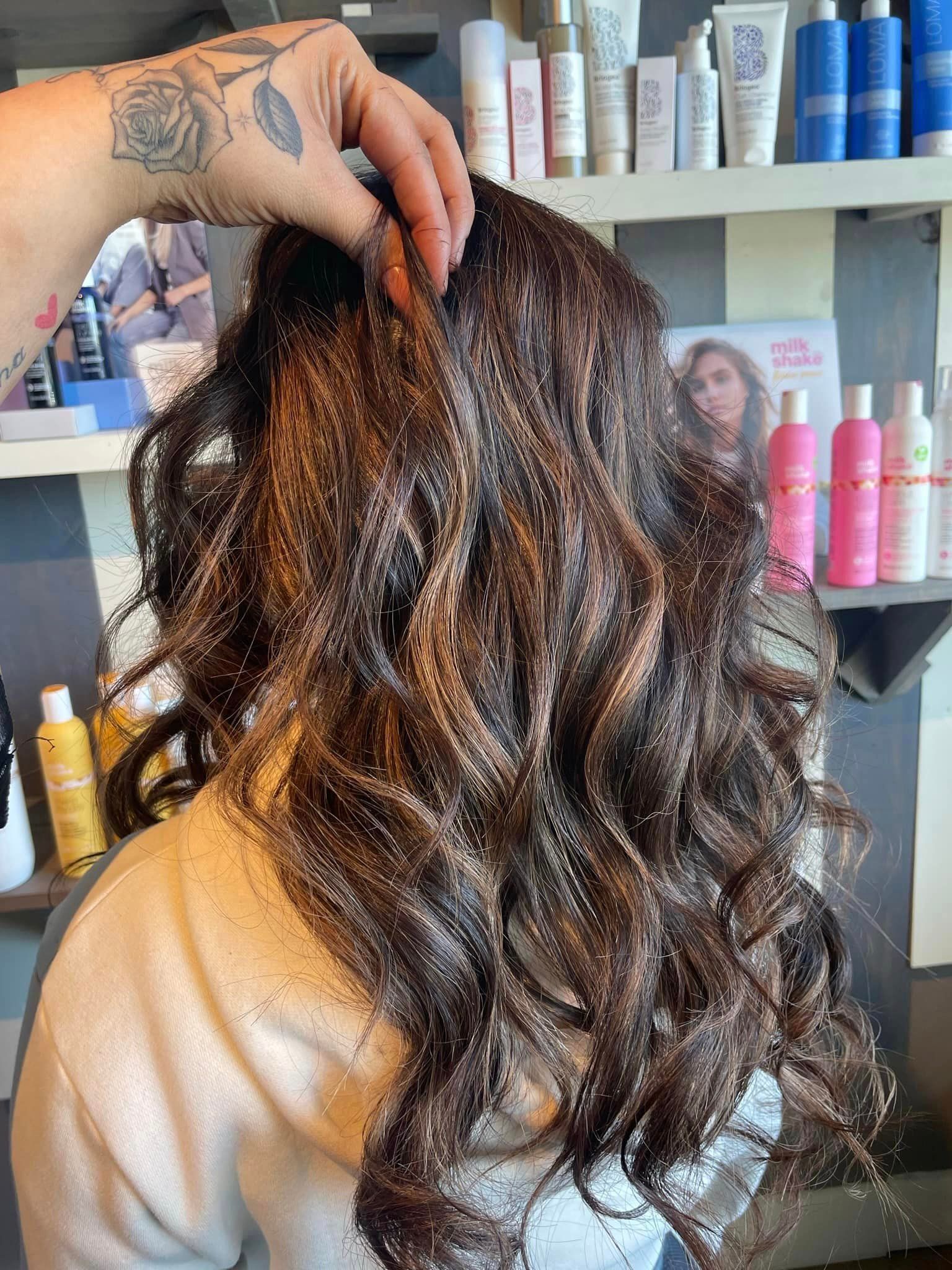 A woman is getting her hair dyed in a salon.