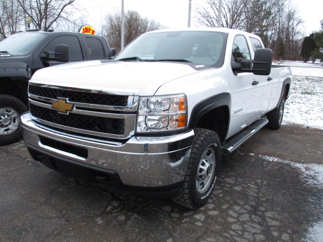 White Chevrolet pickup truck parked outside on a snowy day.