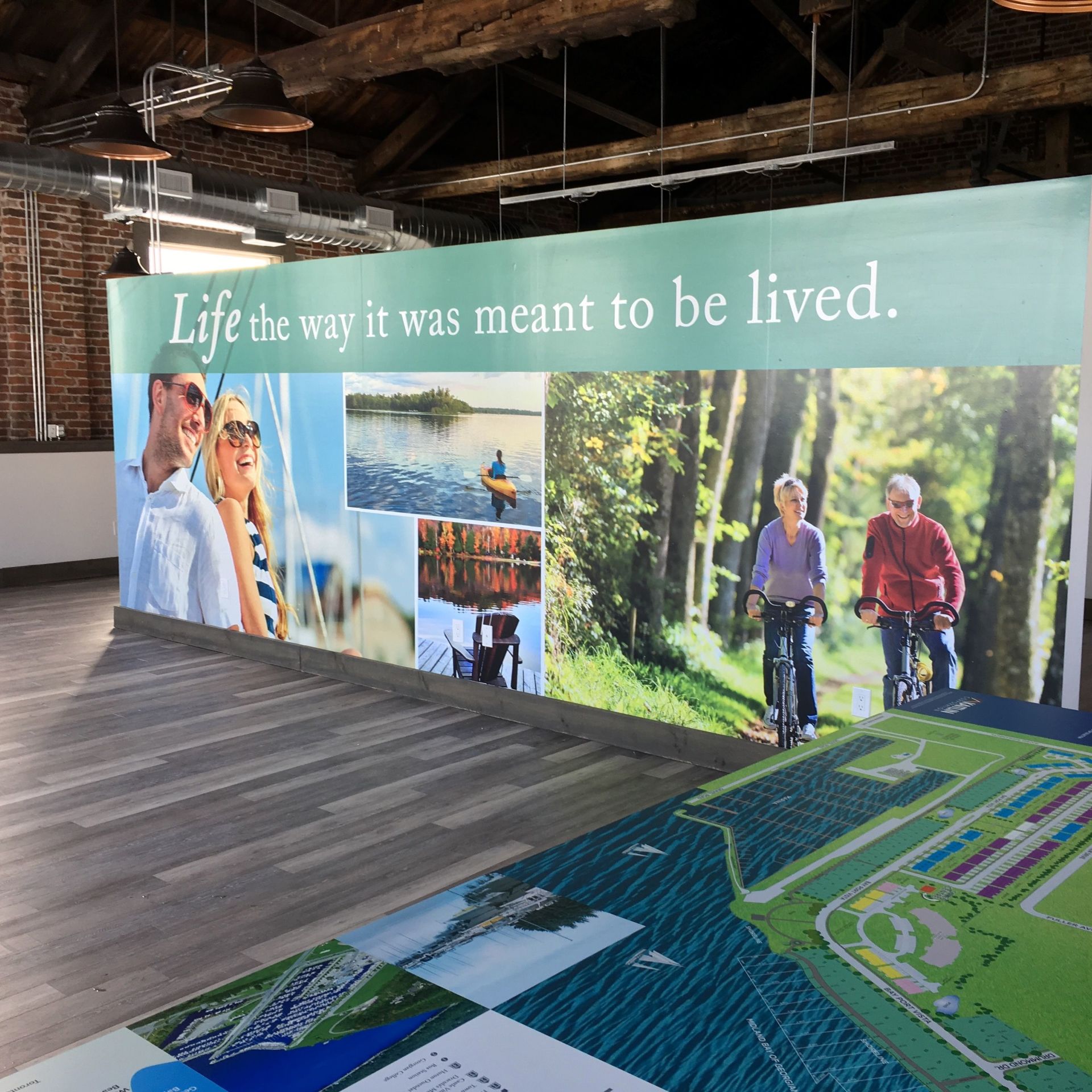 Promotional wall mural with outdoor scenes and the text “Life the way it was meant to be lived.”