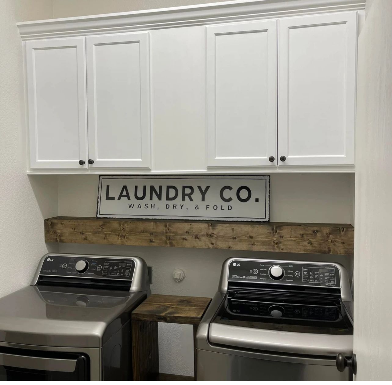 A laundry room with a sign that says laundry co.