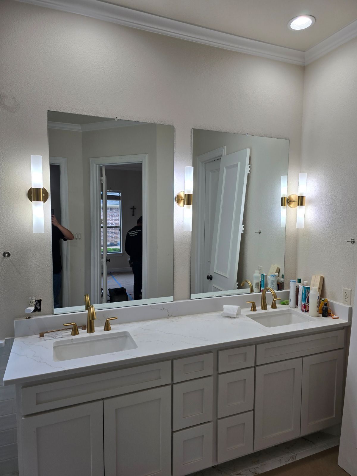 A bathroom with two sinks and two mirrors.